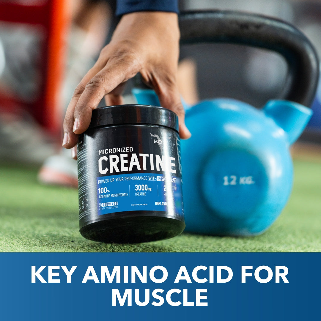 unflavoured, best creatine supplement Person holding a creatine supplement container with a blue kettlebell in the background